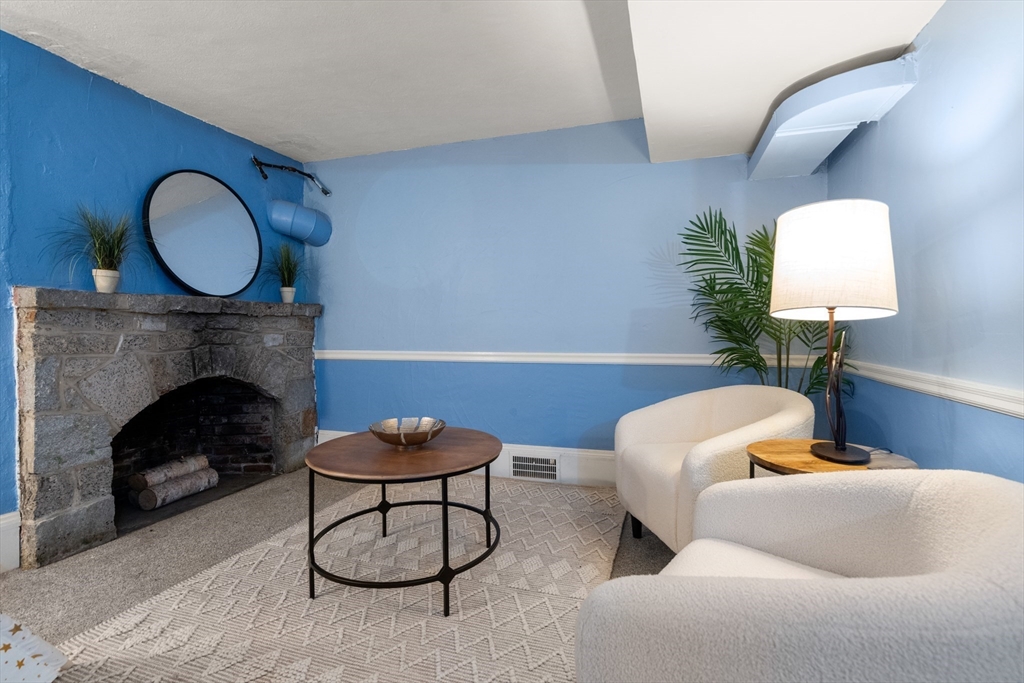 21 Sheldon Road Newton, MA 02459 - Photo 30 of 34 a living room with furniture and a fireplace