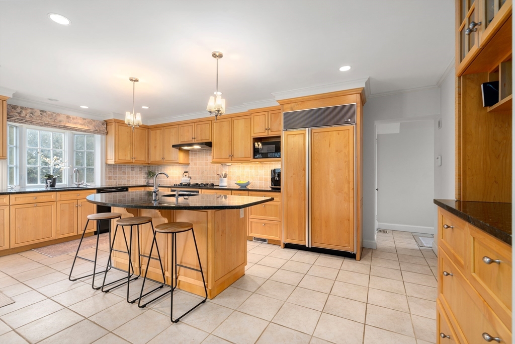 21 Sheldon Road Newton, MA 02459 - Photo 7 of 34 a kitchen with stainless steel appliances a refrigerator a stove a sink a dining table and chairs