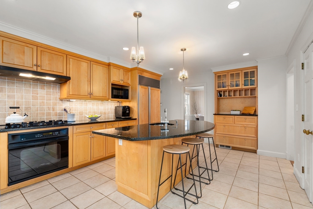 21 Sheldon Road Newton, MA 02459 - Photo 8 of 34 a kitchen with stainless steel appliances granite countertop a stove a sink and a refrigerator