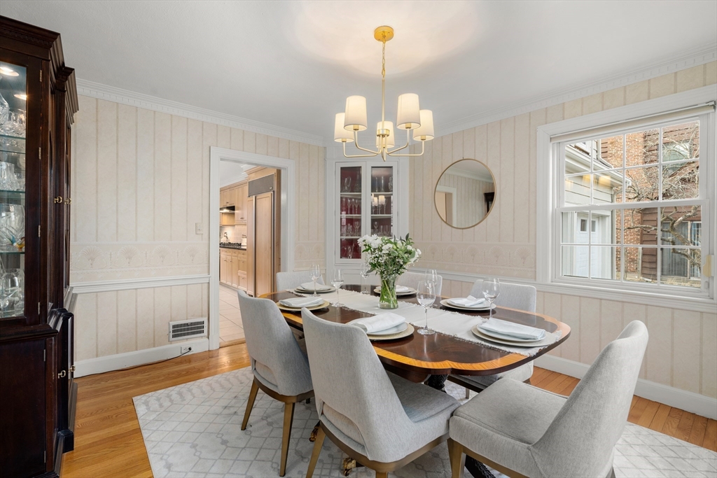 21 Sheldon Road Newton, MA 02459 - Photo 10 of 34 a dining room with wooden floor a chandelier a wooden table and chairs