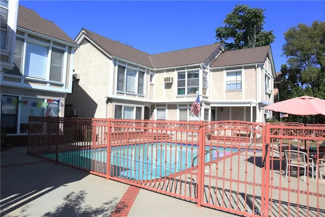 a view of a brick house with many windows