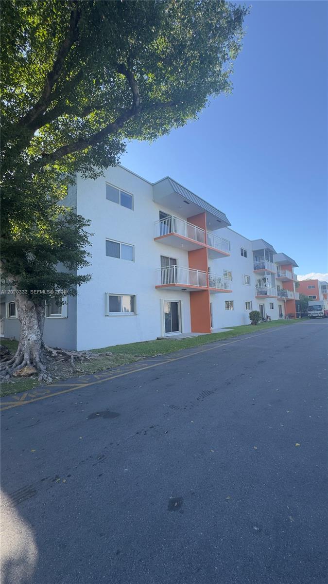 11309 Southwest 200th Street, Unit 103C Miami, FL 33157 - Photo 1 of 18 a view of building with yard