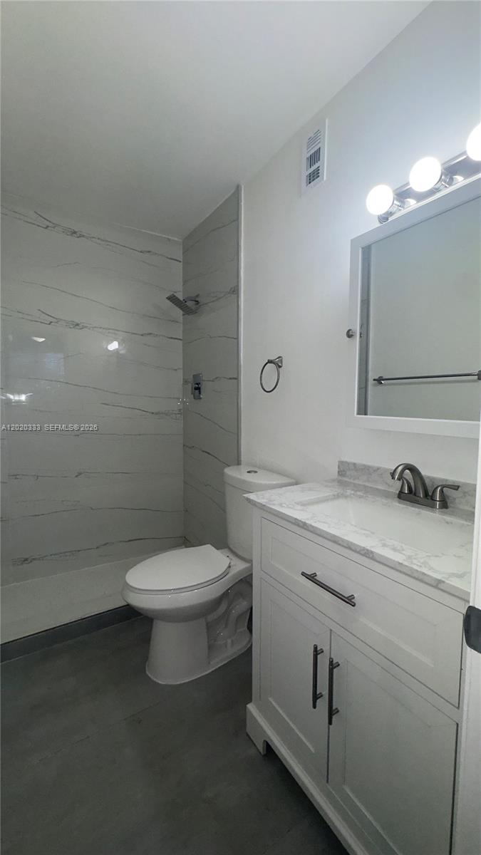 11309 Southwest 200th Street, Unit 103C Miami, FL 33157 - Photo 14 of 18 a bathroom with a toilet sink and shower