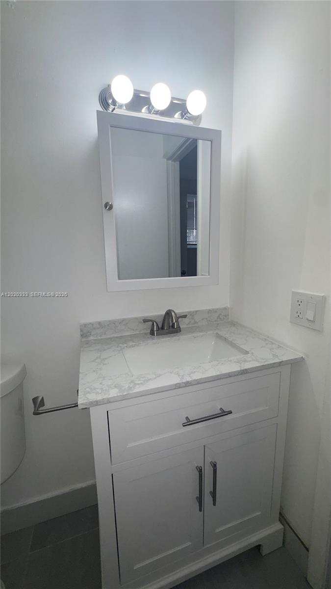 11309 Southwest 200th Street, Unit 103C Miami, FL 33157 - Photo 16 of 18 a bathroom with a sink and a mirror