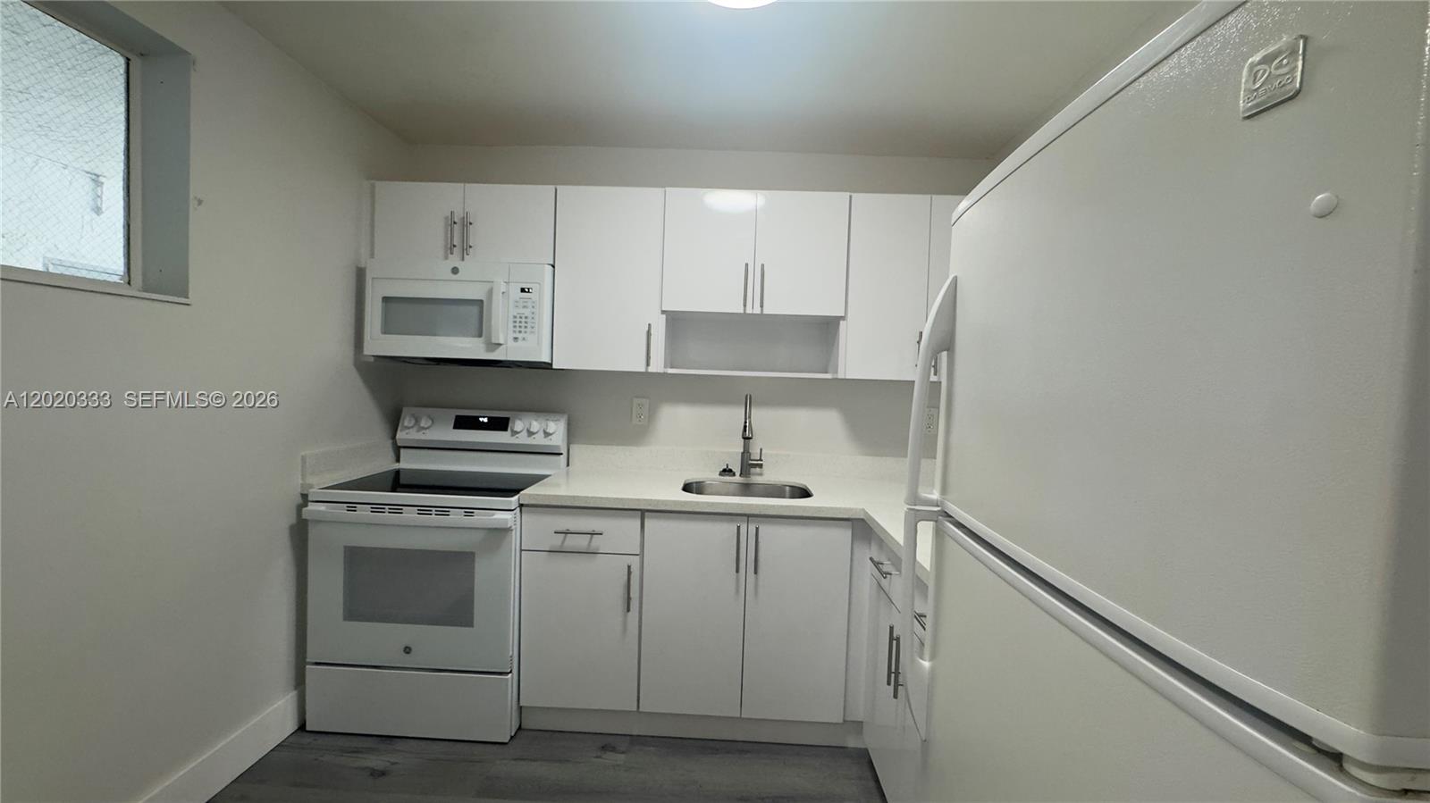 11309 Southwest 200th Street, Unit 103C Miami, FL 33157 - Photo 3 of 18 a kitchen with cabinets appliances and a sink