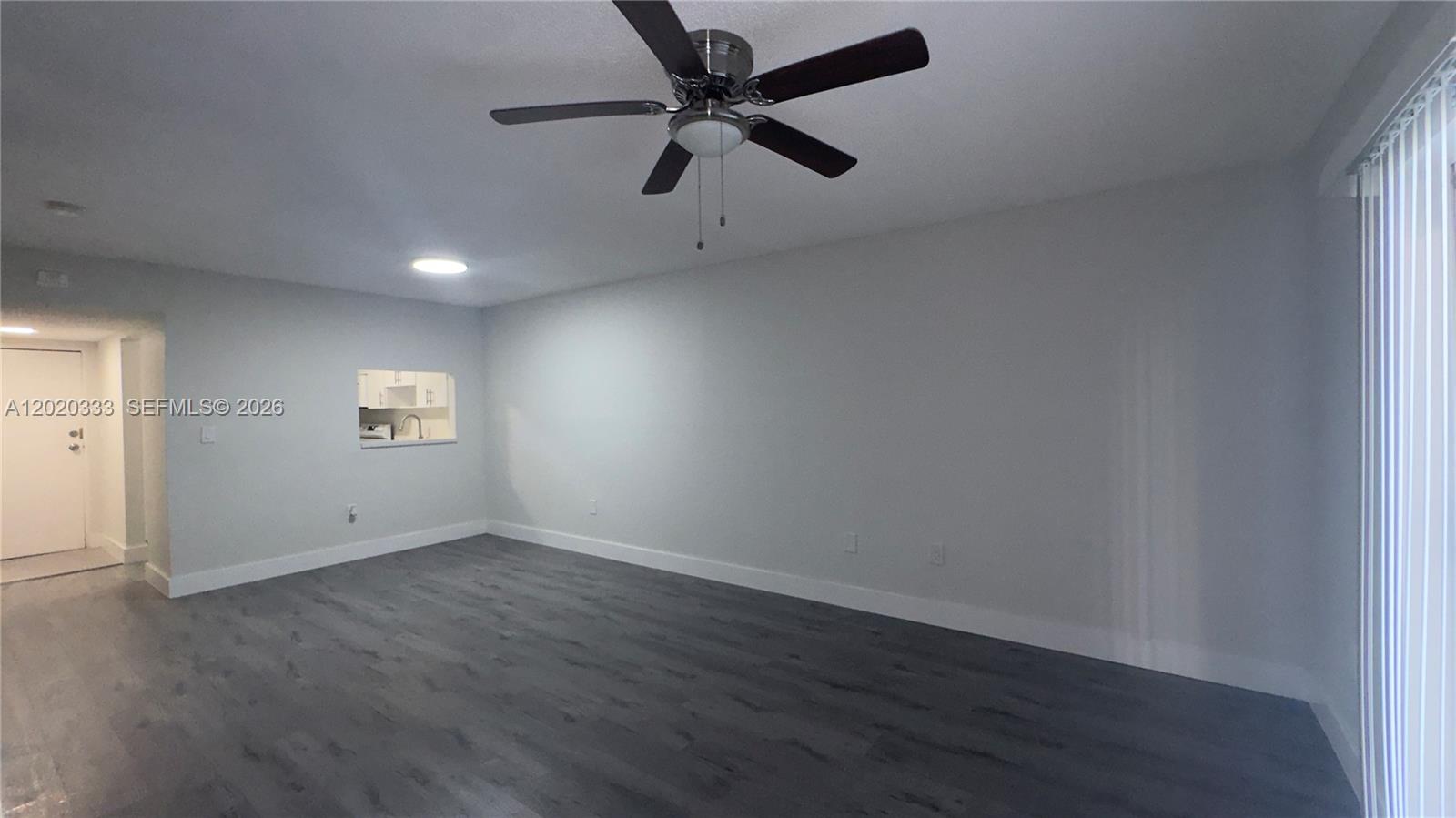 11309 Southwest 200th Street, Unit 103C Miami, FL 33157 - Photo 7 of 18 an empty room with a window and a ceiling fan