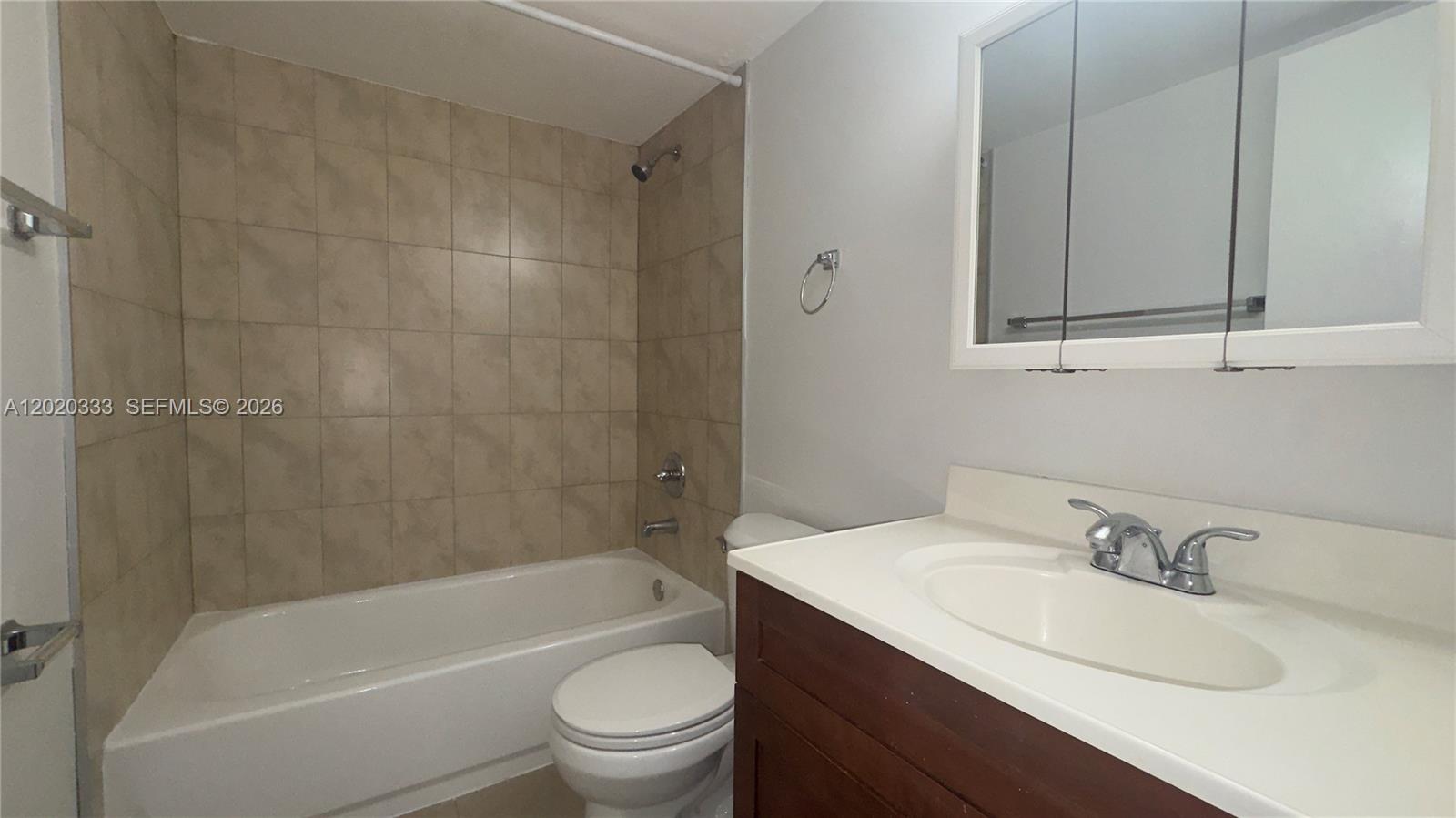11309 Southwest 200th Street, Unit 103C Miami, FL 33157 - Photo 8 of 18 a bathroom with a granite countertop sink toilet and shower