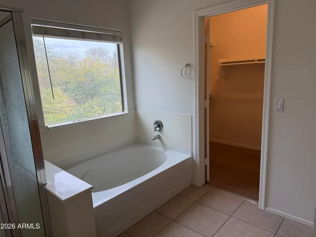 a bathroom with a bathtub and shower