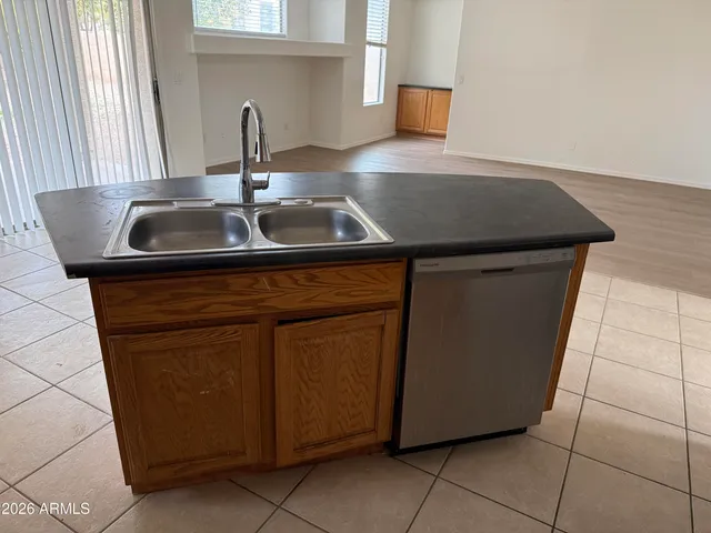 a kitchen with granite countertop a sink and a stove