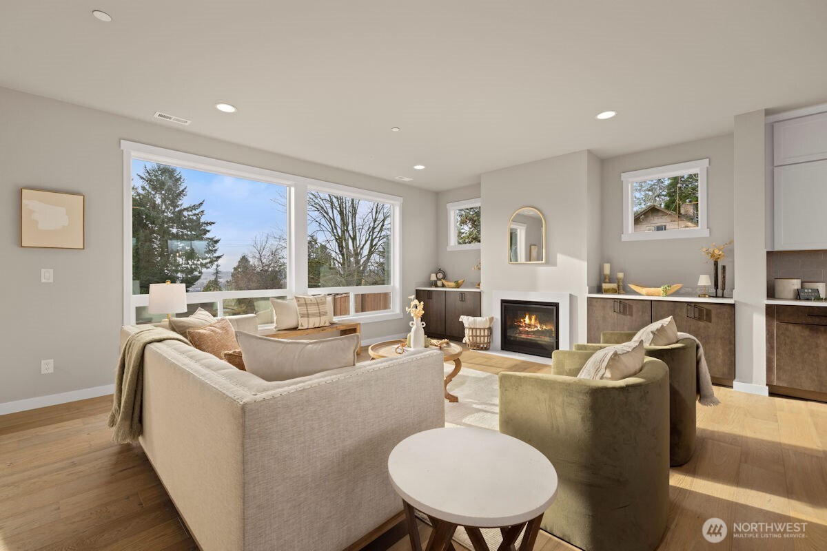 7853 South 132nd Street Seattle, WA 98178 - Photo 13 of 40 a living room with furniture a fireplace and a large window
