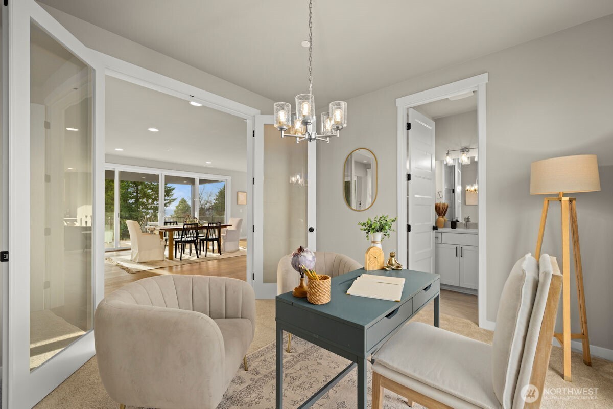 7853 South 132nd Street Seattle, WA 98178 - Photo 21 of 40 a living room with furniture a chandelier a large window and wooden floor
