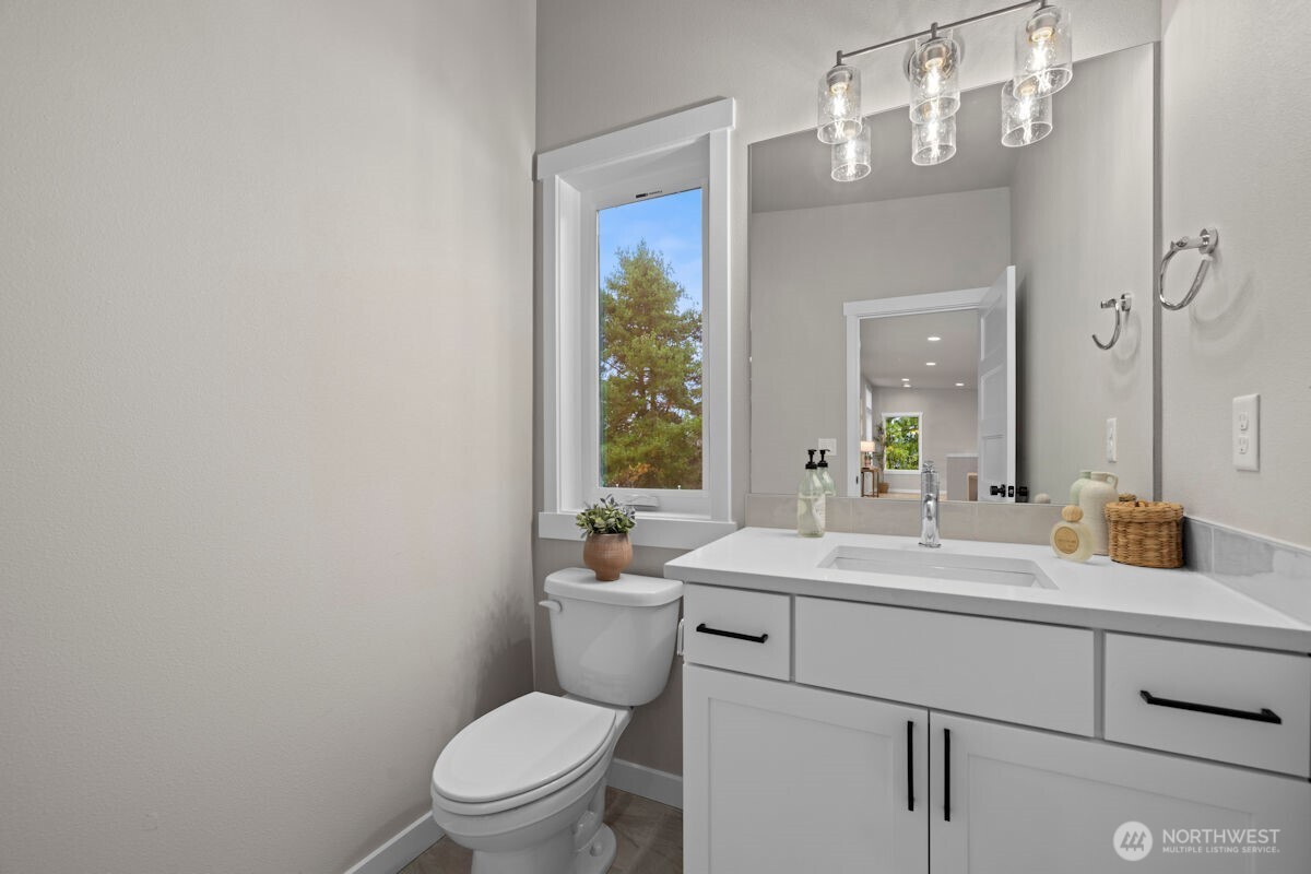 7853 South 132nd Street Seattle, WA 98178 - Photo 35 of 40 a bathroom with a toilet a sink and a mirror