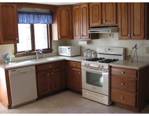 40 Spaulding Road Chelmsford, MA 01824 - Photo 4 of 11 a kitchen with granite countertop a sink cabinets stainless steel appliances and a window
