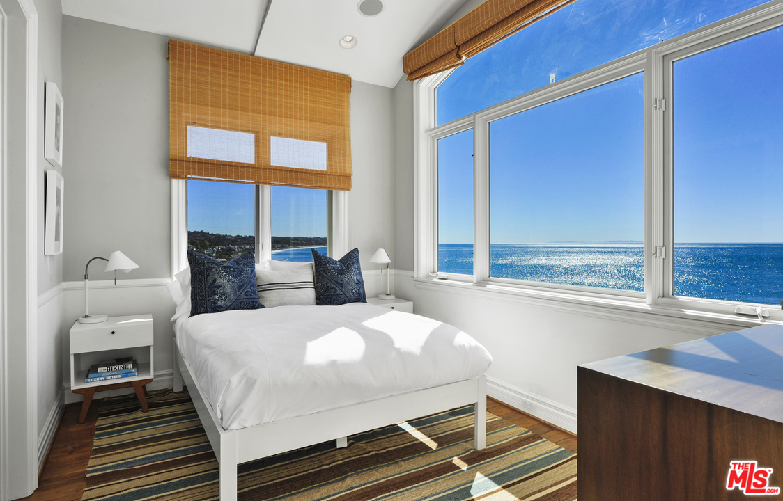 31412 Broad Beach Road Malibu, CA 90265 - Photo 29 of 43 a bedroom with a bed and windows