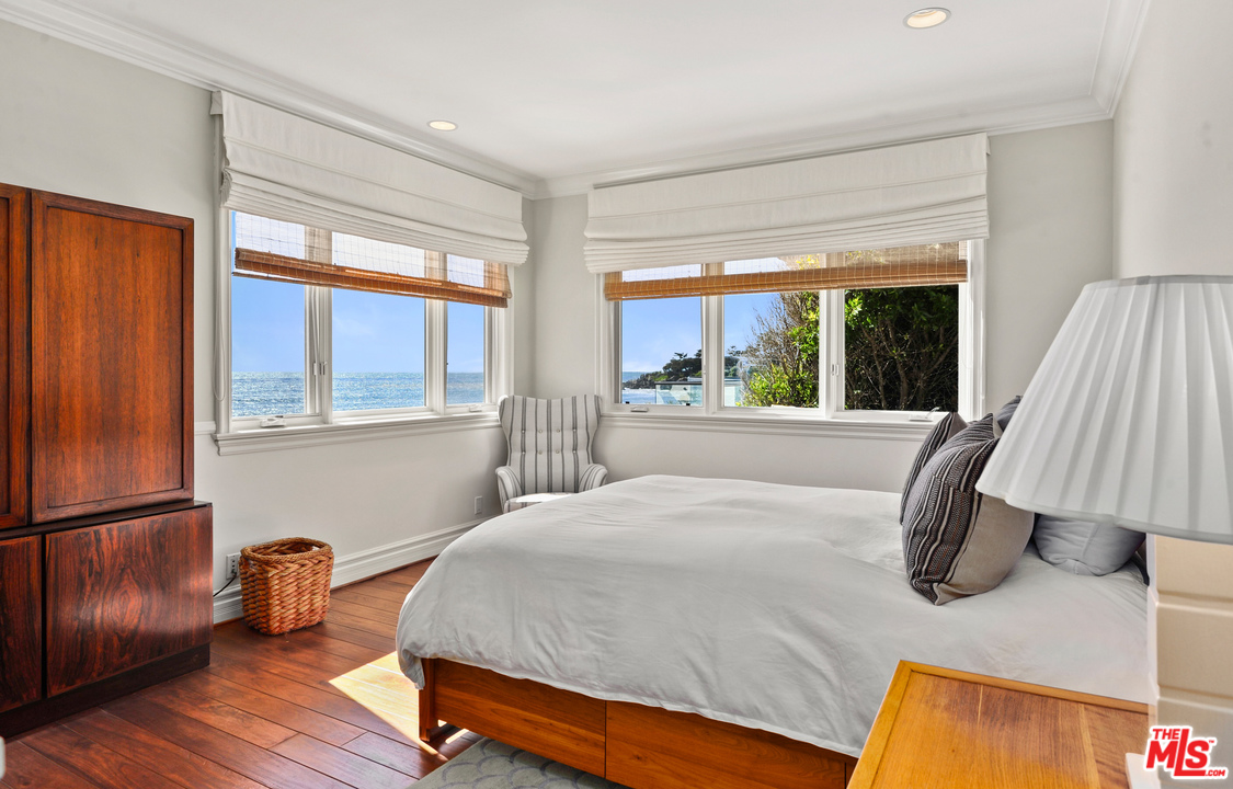 31412 Broad Beach Road Malibu, CA 90265 - Photo 30 of 43 a bedroom with a bed and wooden floor