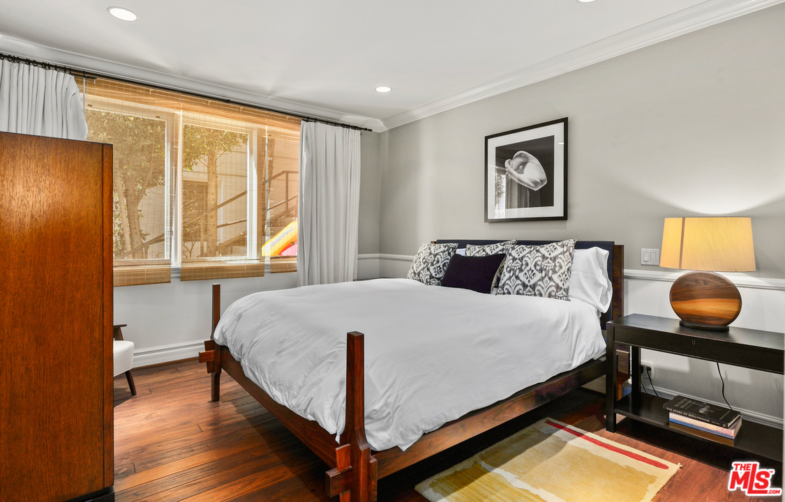 31412 Broad Beach Road Malibu, CA 90265 - Photo 31 of 43 a bedroom with a bed and wooden floor