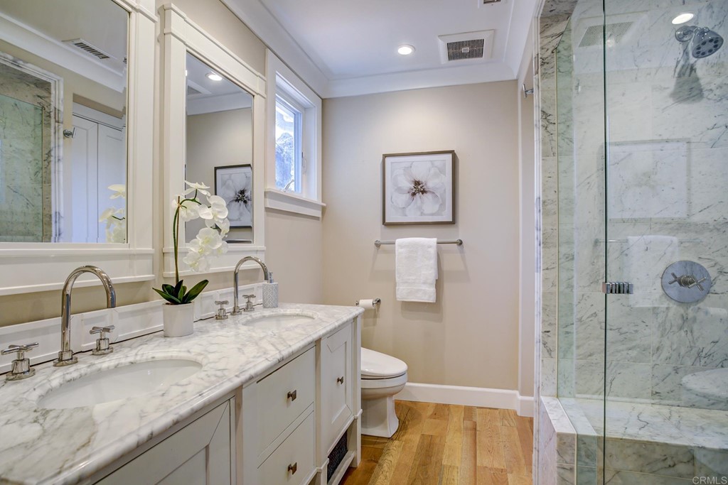 7936 Paseo Del Ocaso La Jolla, CA 92037 - Photo 16 of 43 a bathroom with a granite countertop sink and a mirror