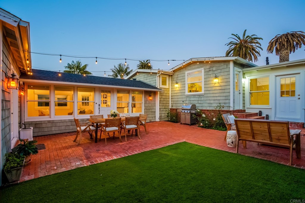 7936 Paseo Del Ocaso La Jolla, CA 92037 - Photo 23 of 43 a view of a house with patio and a yard