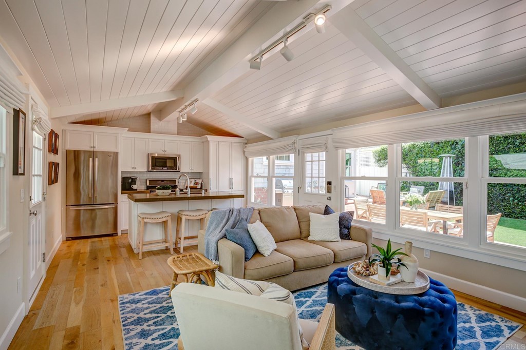 7936 Paseo Del Ocaso La Jolla, CA 92037 - Photo 24 of 43 a living room with stainless steel appliances furniture a rug kitchen view and a large window