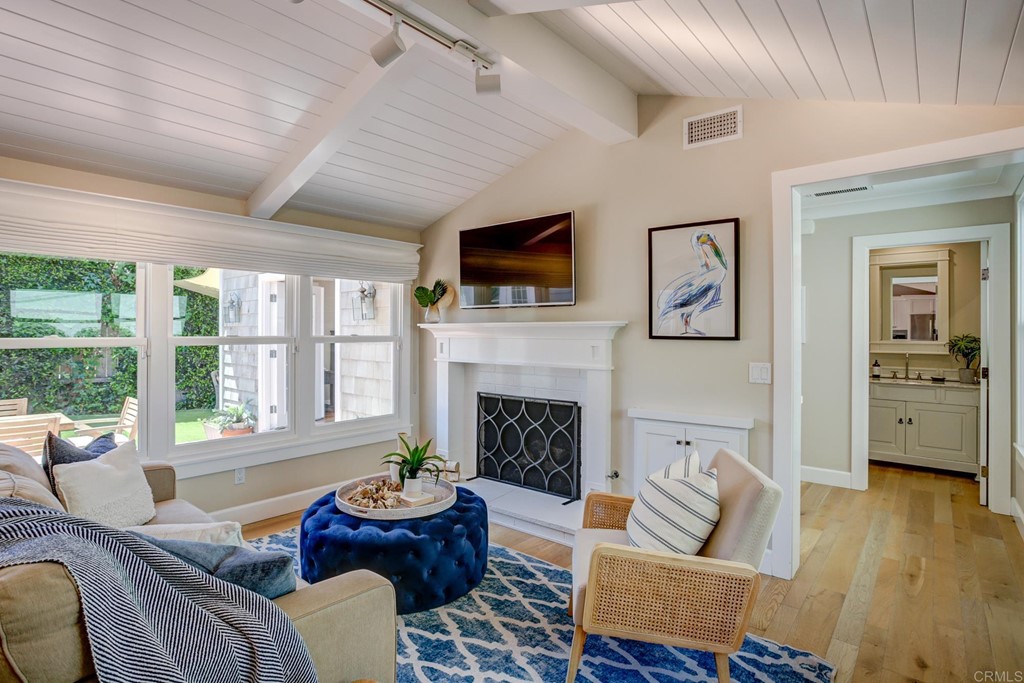 7936 Paseo Del Ocaso La Jolla, CA 92037 - Photo 25 of 43 a living room with furniture fireplace and window