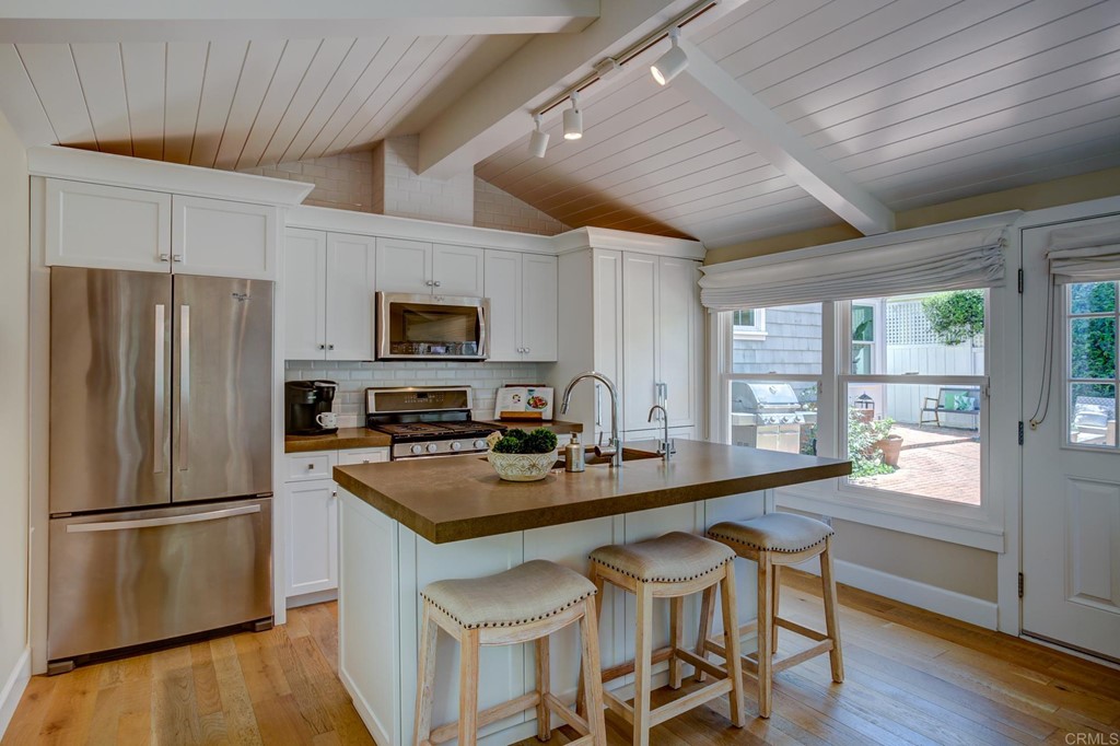 7936 Paseo Del Ocaso La Jolla, CA 92037 - Photo 27 of 43 a kitchen with a sink a counter space appliances and cabinets