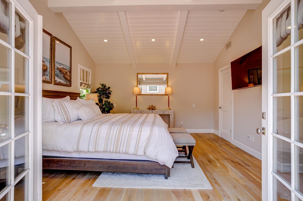 7936 Paseo Del Ocaso La Jolla, CA 92037 - Photo 30 of 43 a bedroom with a bed and a flat screen tv