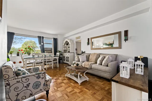a living room with furniture and painting on the wall