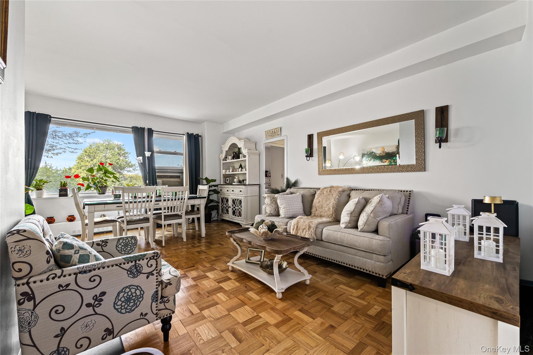 a living room with furniture and painting on the wall