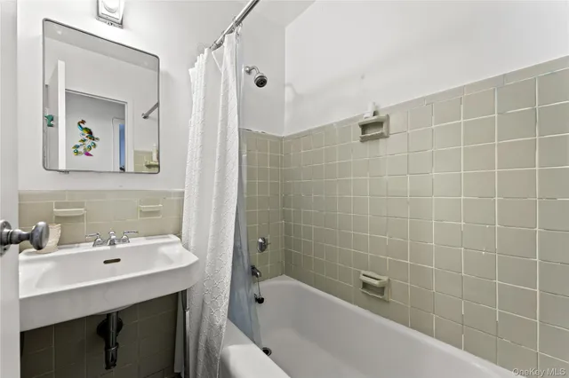 a bathroom with a sink mirror and shower