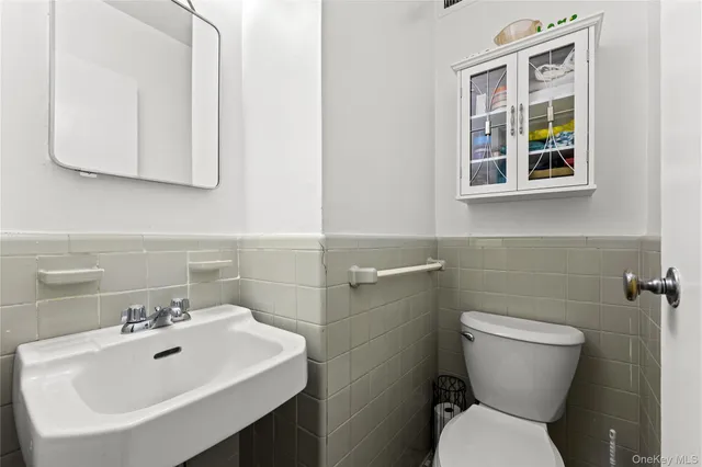 a bathroom with a sink mirror and toilet