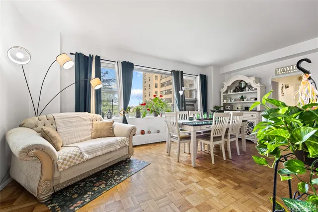 a living room with furniture a large window and a table