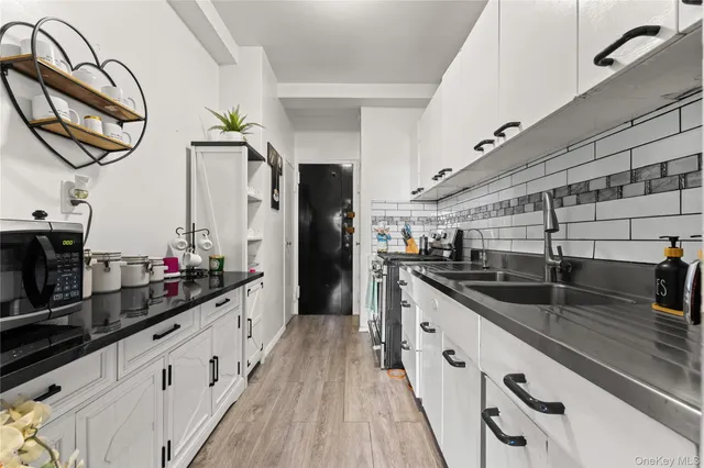 a kitchen with sink cabinets and stove