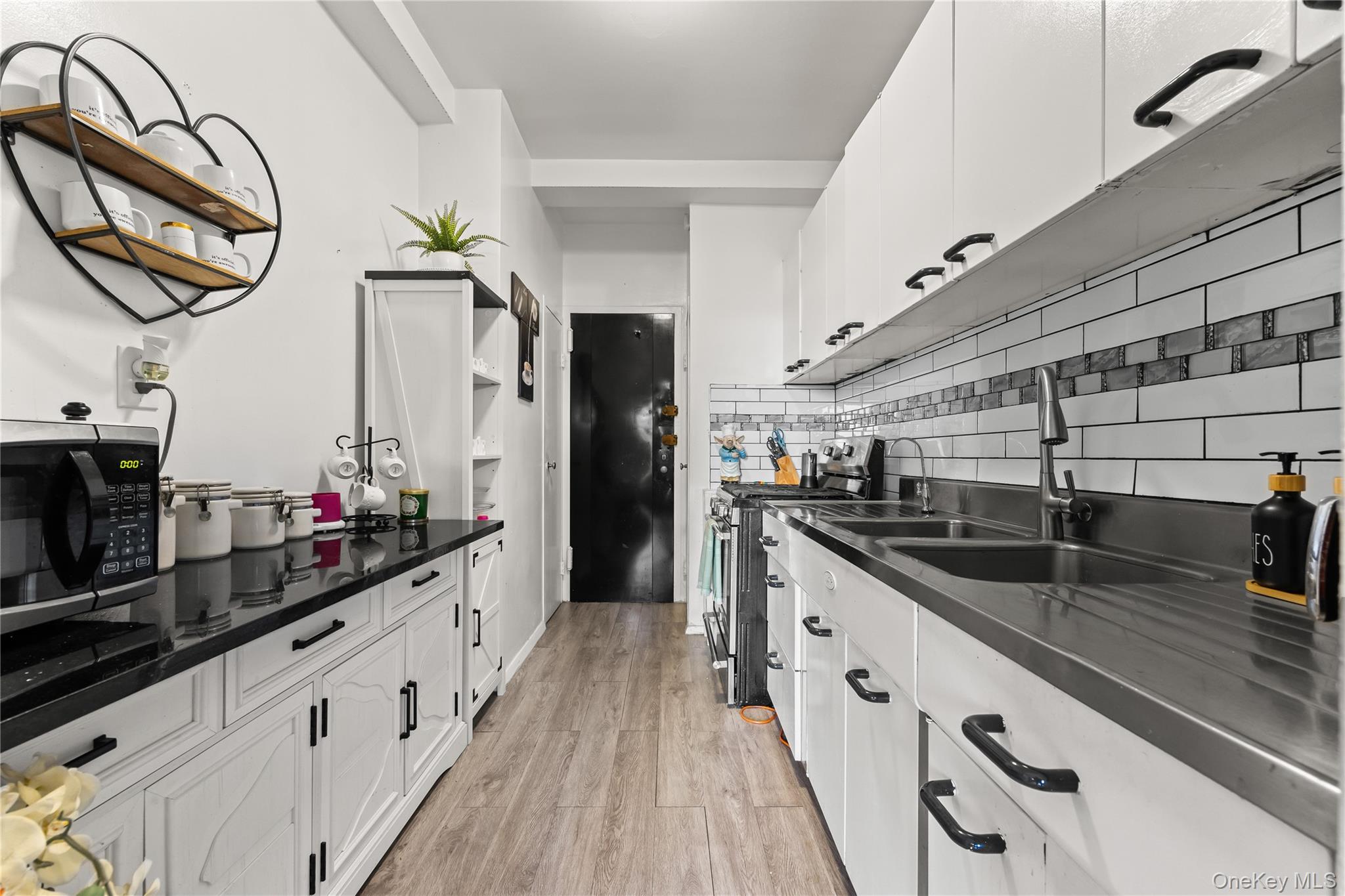 3 Fordham Hill Ovl, Unit 3C Bronx, NY 10468 - Photo 7 of 24 a kitchen with sink cabinets and stove