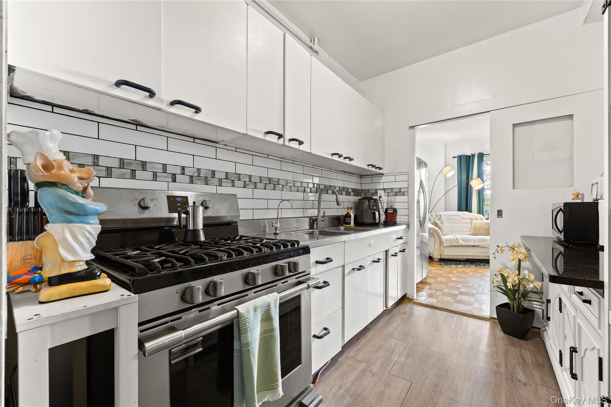 3 Fordham Hill Ovl, Unit 3C Bronx, NY 10468 - Photo 9 of 24 a kitchen with stainless steel appliances a stove a sink and a refrigerator