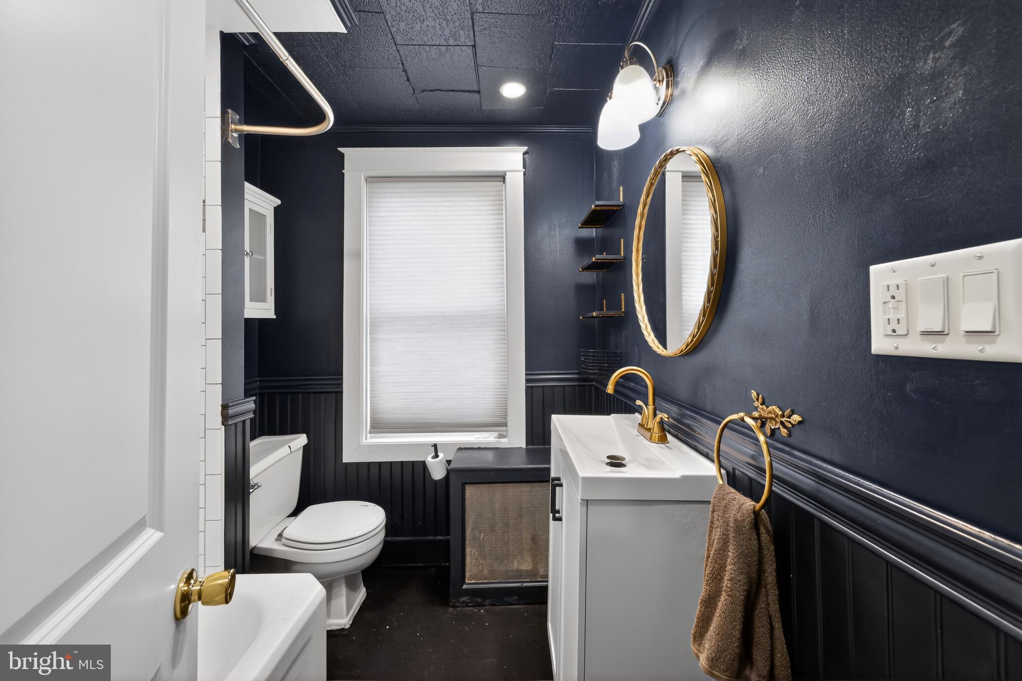 108 South Pearl Street Lancaster, PA 17603 - Photo 20 of 30 a bathroom with a toilet sink and mirror