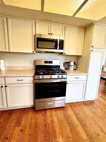 a kitchen with a sink a stove and microwave