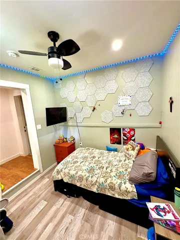 a bedroom with a bed and a flat screen tv