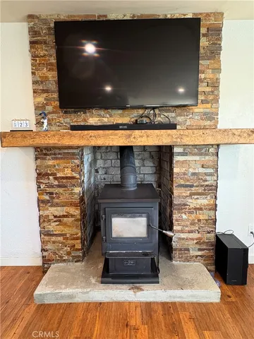 a living room with fireplace and a wooden floor
