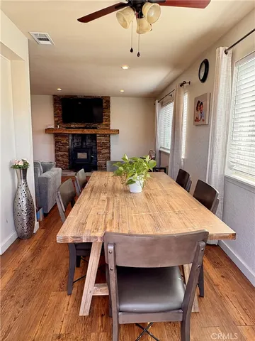 a dining room with a table chairs and a kitchen