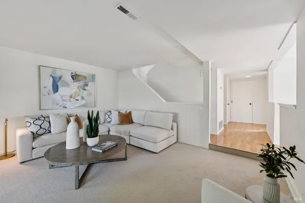 a living room with fireplace furniture and a flat screen tv