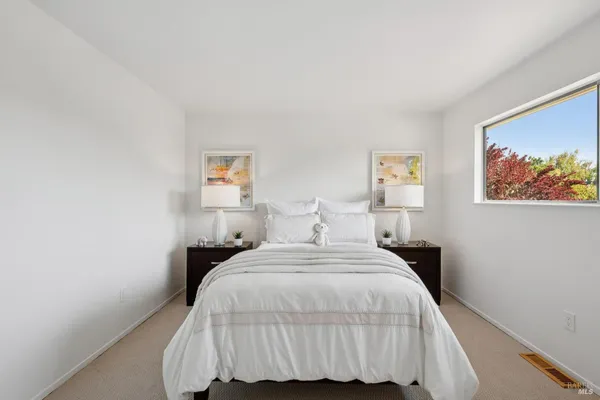 a bedroom with a bed and a night stand