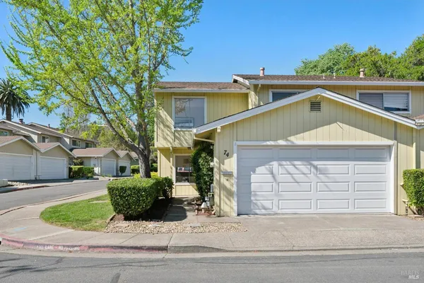 a front view of a house with garden