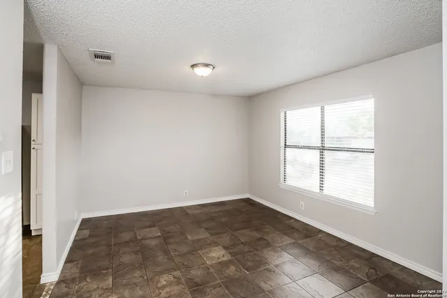 an empty room with a empty space and windows