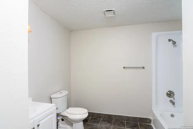 a white toilet sitting next to a bathroom sink