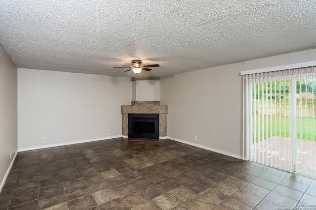 a view of an empty room with a fireplace