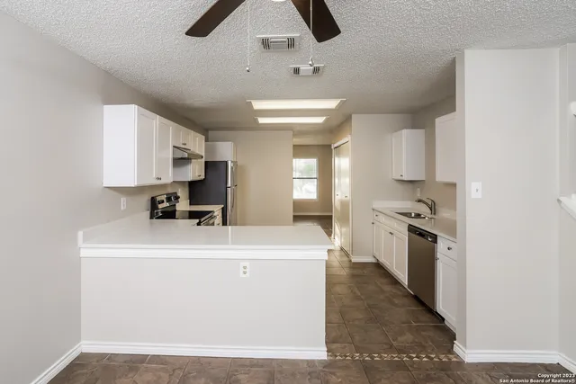 a kitchen with stainless steel appliances a sink stove and refrigerator