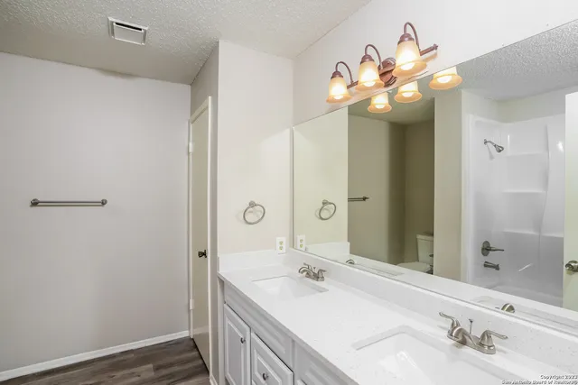 a bathroom with a sink a mirror and a shower