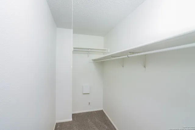 a view of an empty walk in closet