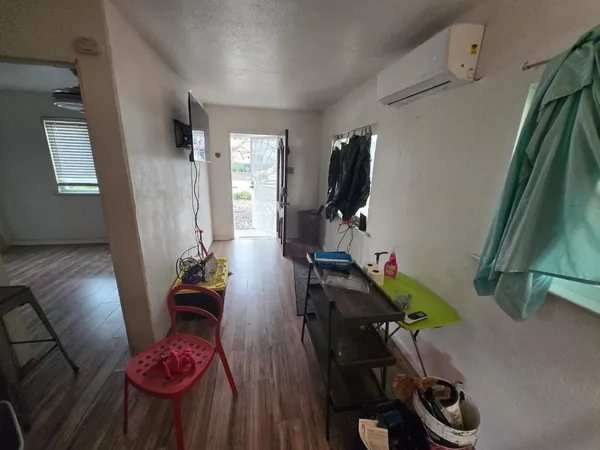 a kitchen that has a sink cabinets and wooden floor