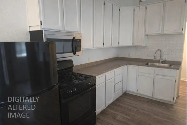 a kitchen with a sink and cabinets